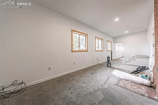 a view of a livingroom with wooden floor and a window