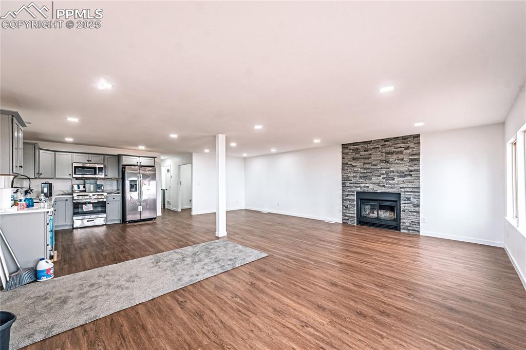 12480 Partridge Lane Peyton, CO 80831 - Photo 5 of 38 a view of a kitchen with cabinets potted plant and wooden floor