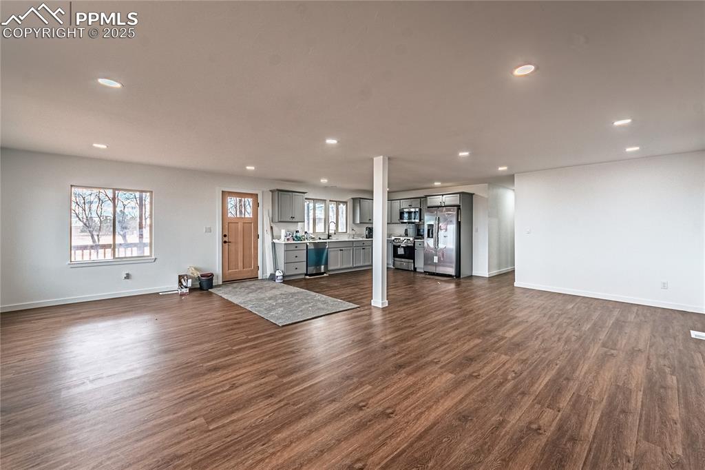 12480 Partridge Lane Peyton, CO 80831 - Photo 6 of 38 an empty room with wooden floor and windows
