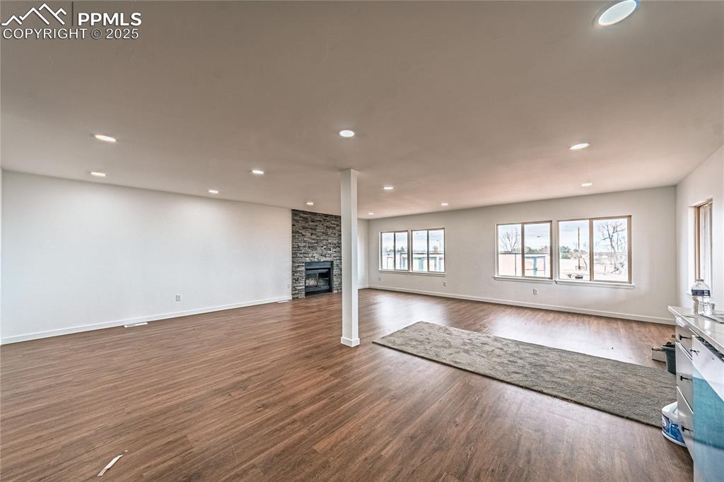 12480 Partridge Lane Peyton, CO 80831 - Photo 8 of 38 an empty room with wooden floor and windows