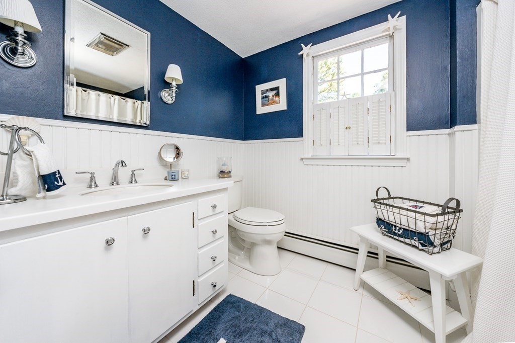 104 Cherry Tree Road Barnstable, MA 02635 - Photo 15 of 22 a bathroom with a toilet a sink and mirror