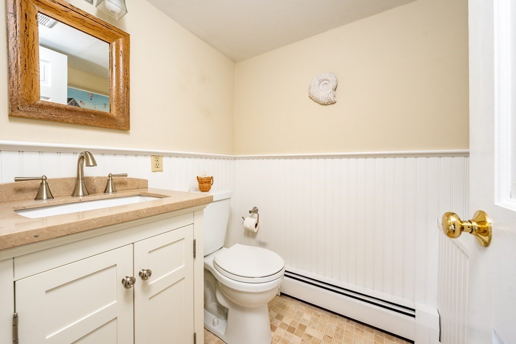 104 Cherry Tree Road Barnstable, MA 02635 - Photo 18 of 22 a bathroom with a toilet sink vanity and mirror