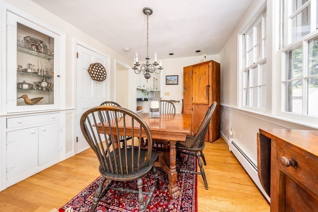 104 Cherry Tree Road Barnstable, MA 02635 - Photo 4 of 22 a dining room with furniture chandelier and wooden floor