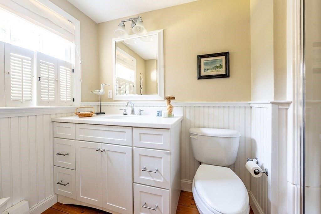 104 Cherry Tree Road Barnstable, MA 02635 - Photo 7 of 22 a bathroom with a toilet sink and mirror