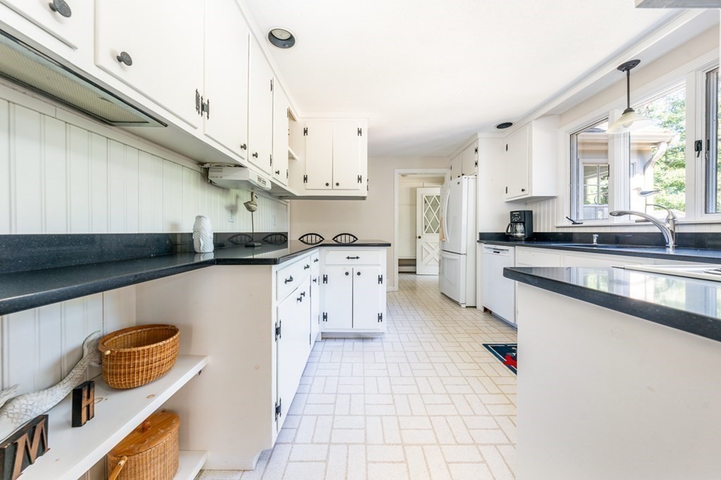 104 Cherry Tree Road Barnstable, MA 02635 - Photo 9 of 22 a kitchen with stainless steel appliances granite countertop a sink a stove and a refrigerator