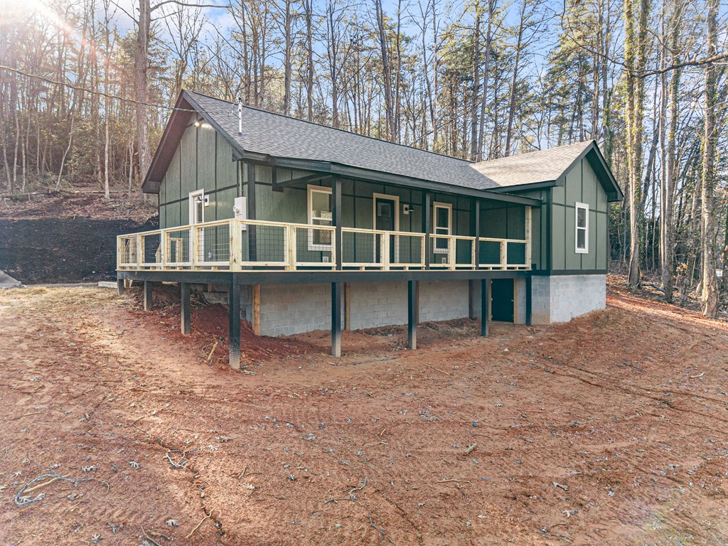 1410 Sky Lake Road Sautee Nacoochee, GA 30571 - Photo 2 of 37 a front view of a house with a yard and balcony