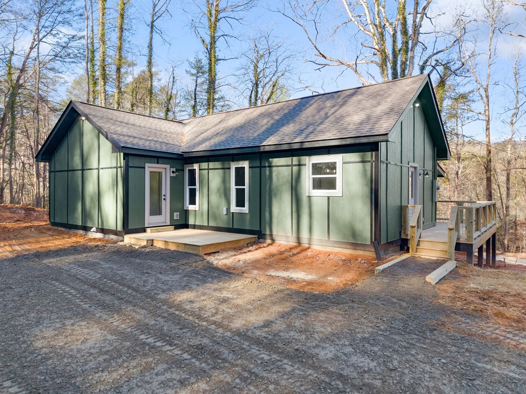 1410 Sky Lake Road Sautee Nacoochee, GA 30571 - Photo 24 of 37 a backyard of a house with large trees and a barn