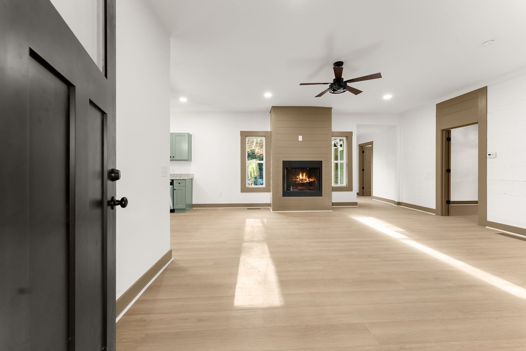 1410 Sky Lake Road Sautee Nacoochee, GA 30571 - Photo 26 of 37 an empty room with windows and a fireplace