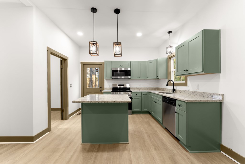 1410 Sky Lake Road Sautee Nacoochee, GA 30571 - Photo 3 of 37 a kitchen with kitchen island granite countertop a sink a counter space appliances and cabinets