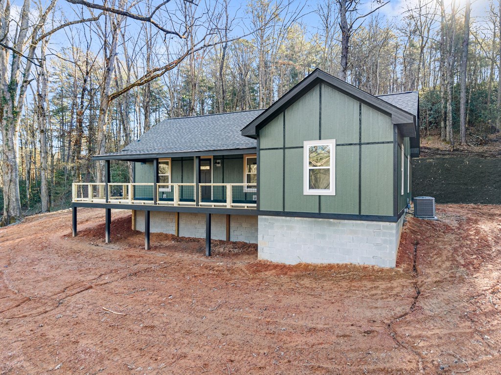 1410 Sky Lake Road Sautee Nacoochee, GA 30571 - Photo 4 of 37 a front view of a house with a yard and trees