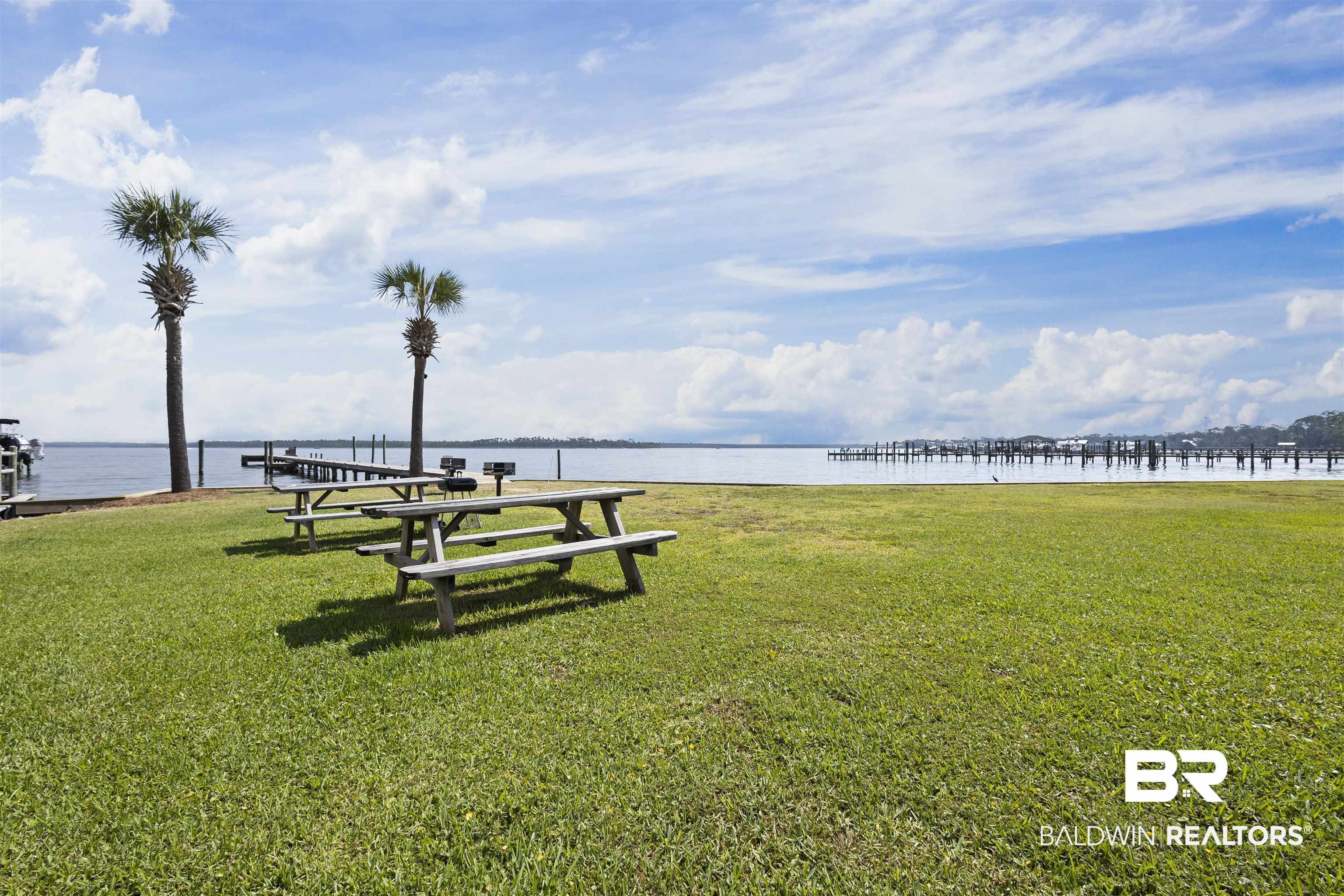 25925 Canal Road, Unit 207 Orange Beach, AL 36561 - Photo 32 of 42 View of nearby features with a yard, a boat dock, and a water view