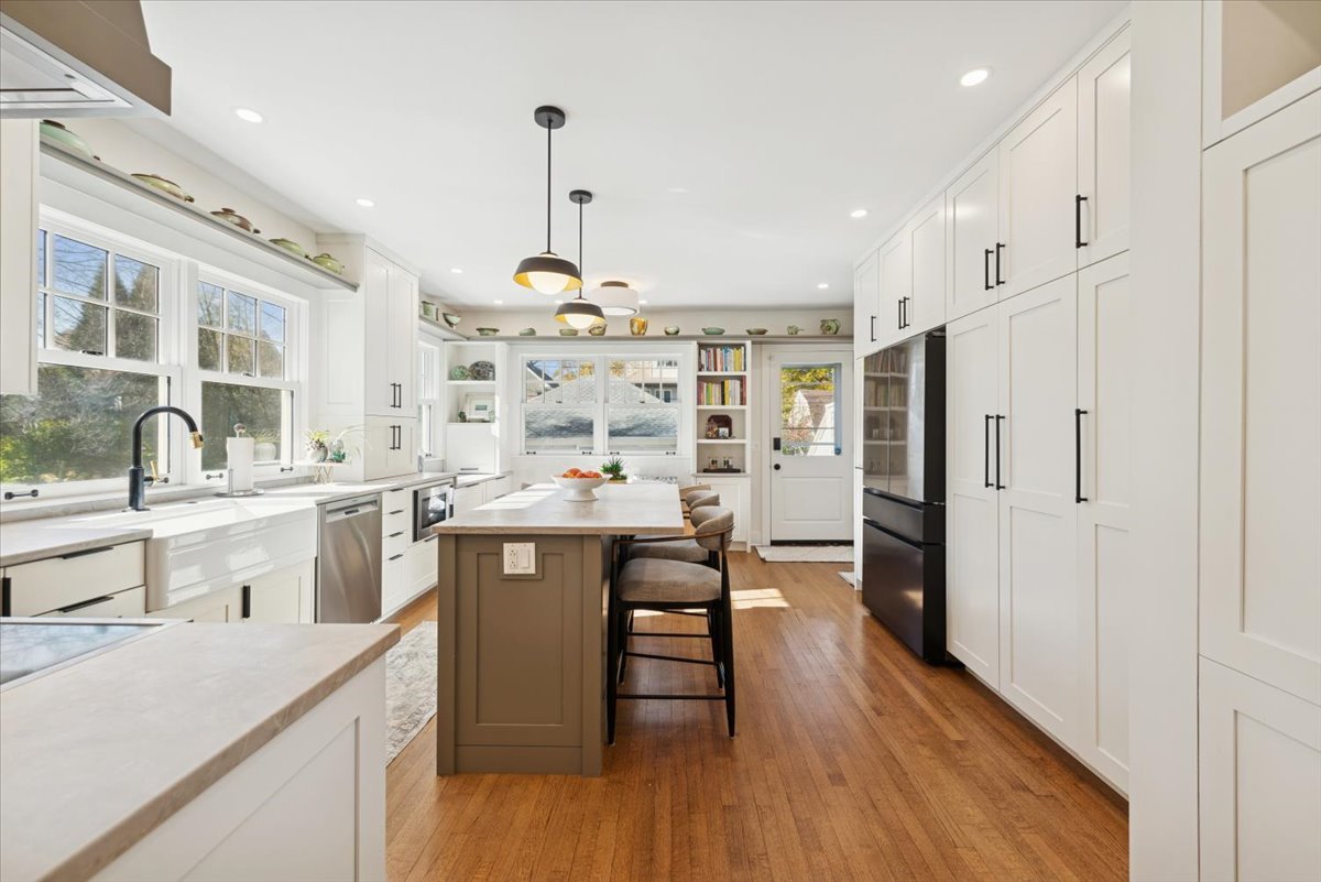 1570 Ashland Avenue Evanston, IL 60201 - Photo 16 of 40 a kitchen with stainless steel appliances a sink a stove a refrigerator cabinets and wooden floor