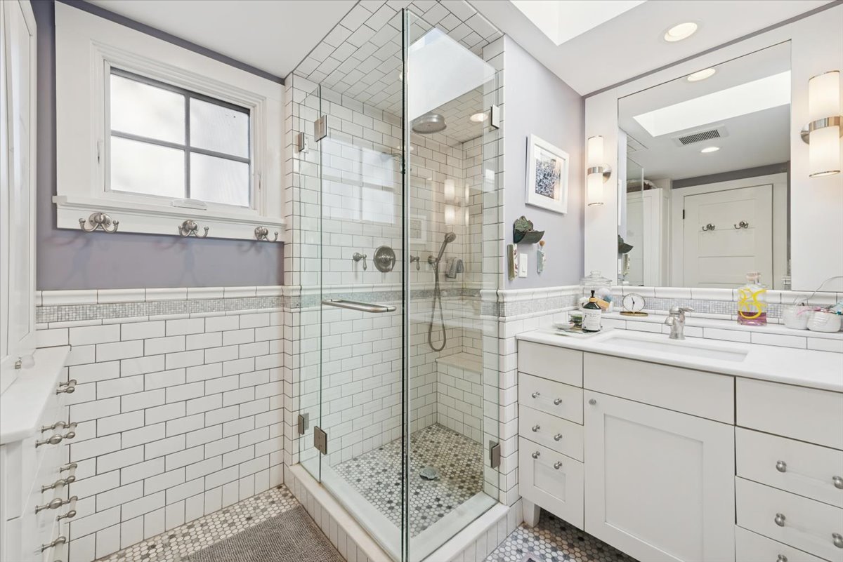 1570 Ashland Avenue Evanston, IL 60201 - Photo 31 of 40 a bathroom with a shower sink and mirror