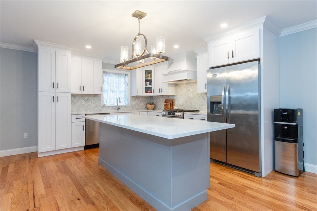 21 Juniper Road Norton, MA 02766 - Photo 12 of 33 a kitchen with kitchen island granite countertop a sink a counter space and stainless steel appliances