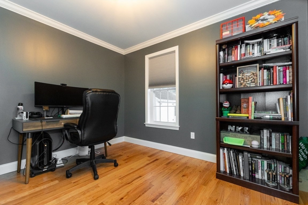 21 Juniper Road Norton, MA 02766 - Photo 17 of 33 a view of a workspace with bookshelf and a window