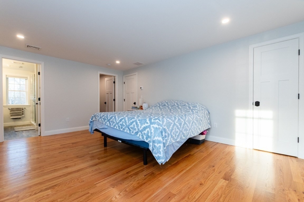 21 Juniper Road Norton, MA 02766 - Photo 18 of 33 a bedroom with a bed and wooden floor