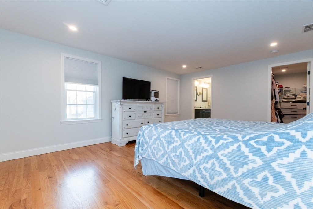 21 Juniper Road Norton, MA 02766 - Photo 19 of 33 a spacious bedroom with a bed and a flat screen tv