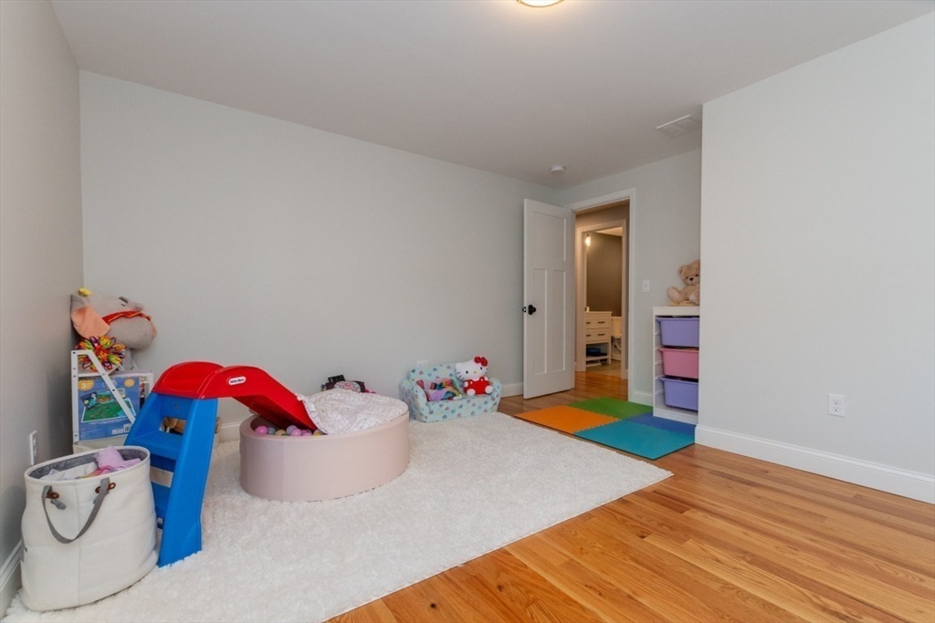 21 Juniper Road Norton, MA 02766 - Photo 25 of 33 a bedroom with a bed and wooden floor