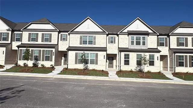 a front view of a residential apartment building with a yard