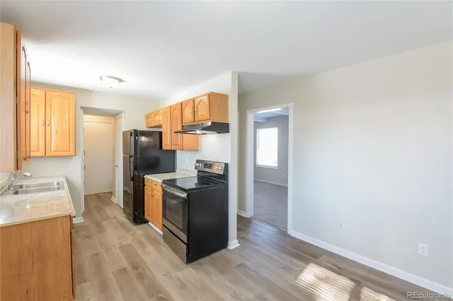 a kitchen with stainless steel appliances a refrigerator and a stove top oven