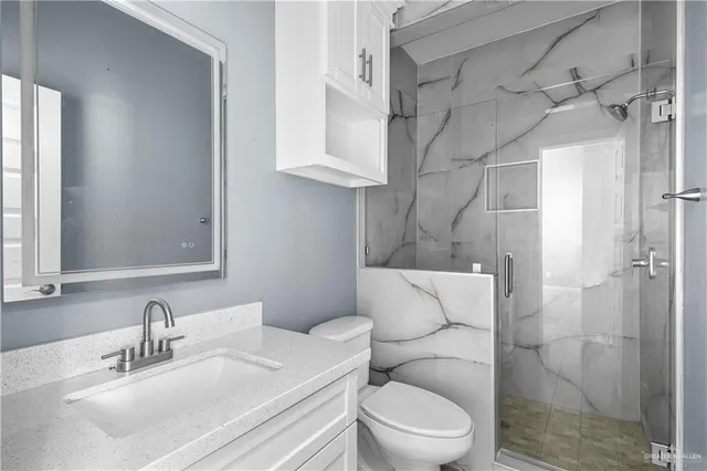 a bathroom with a toilet sink and shower