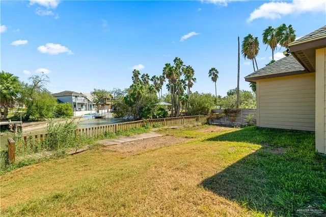 a view of a swimming pool with a yard