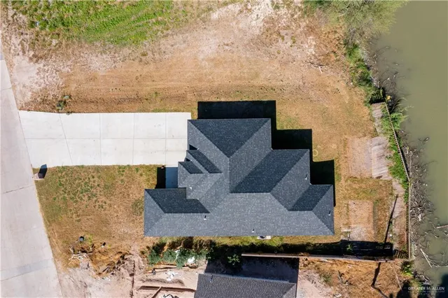 an aerial view of a house with yard