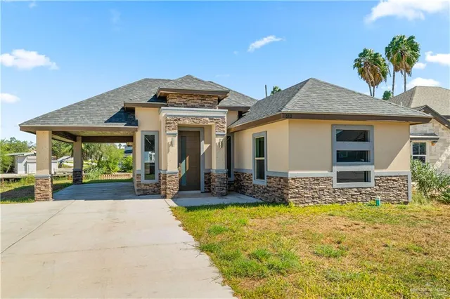 a front view of a house with garden