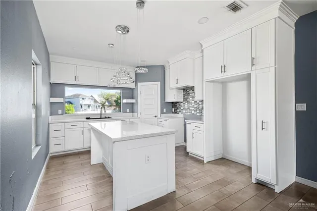a kitchen with white cabinets and white appliances