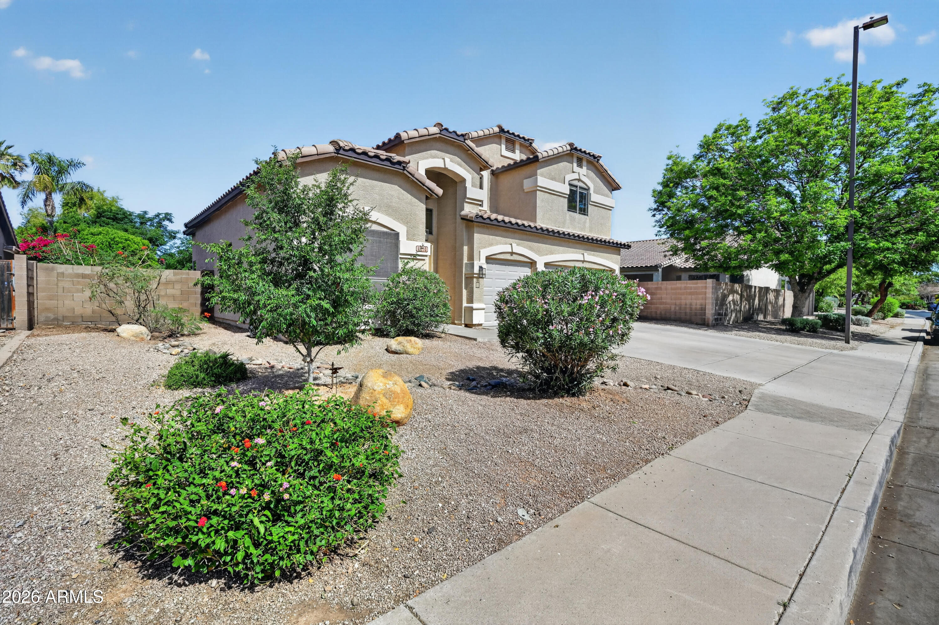 1414 South Sandstone Street Gilbert, AZ 85296 - Photo 1 of 43 a front view of a house with a yard and potted plants