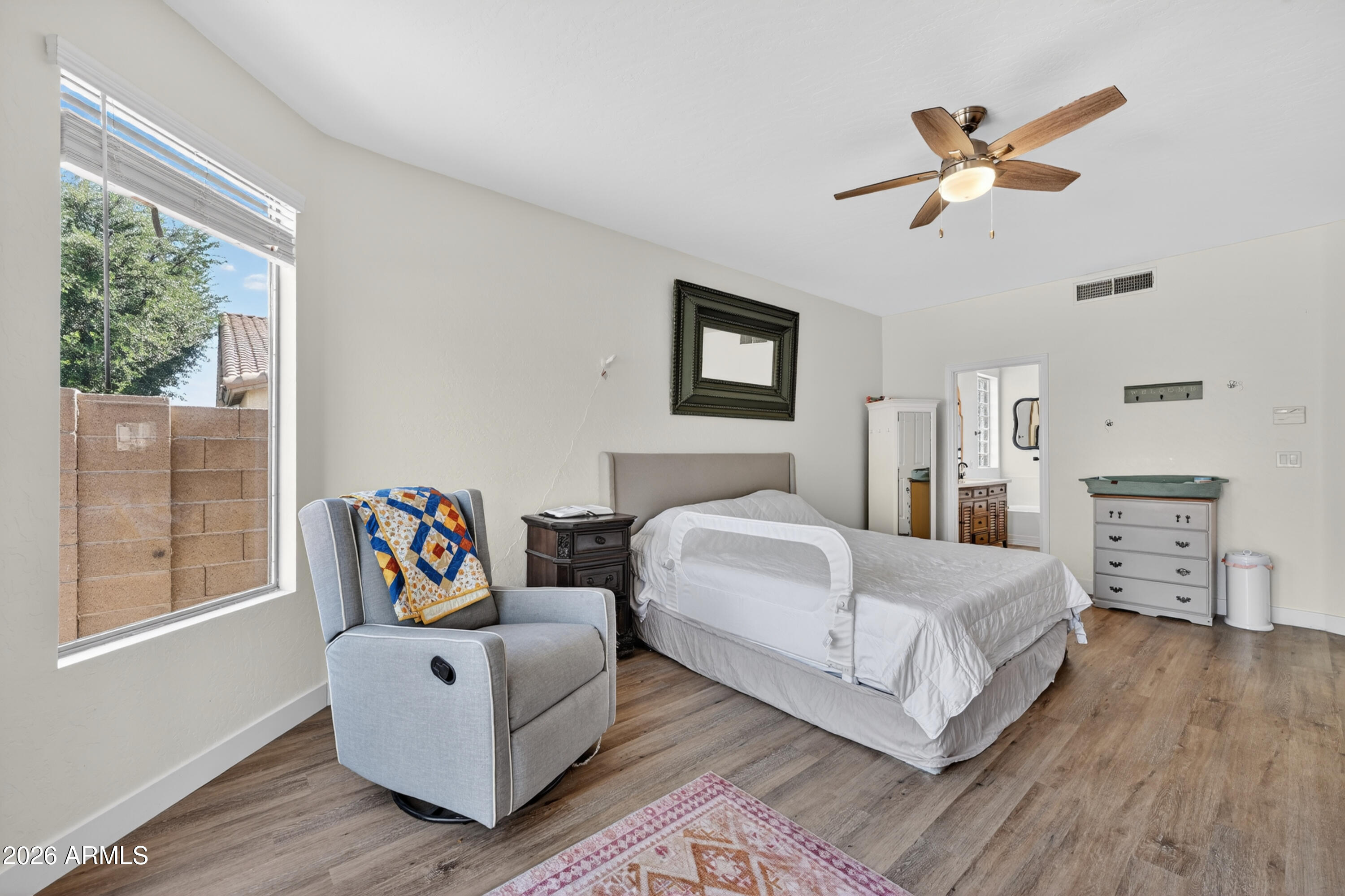 1414 South Sandstone Street Gilbert, AZ 85296 - Photo 19 of 43 a bedroom with a bed and wooden floor