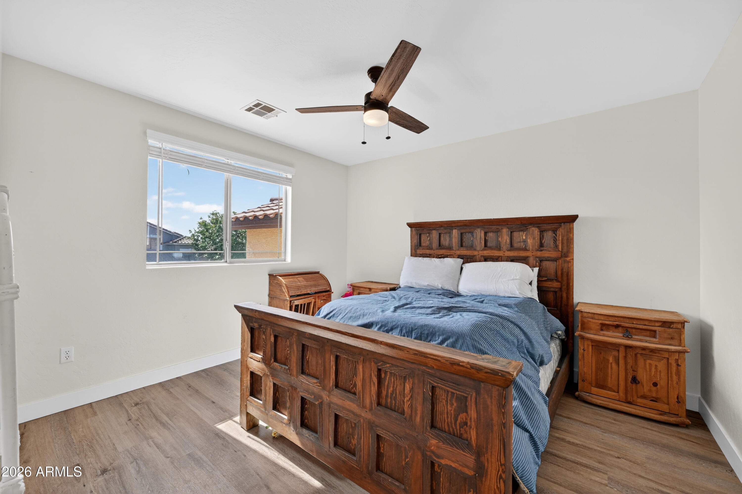 1414 South Sandstone Street Gilbert, AZ 85296 - Photo 28 of 43 a bedroom with a bed and wooden floor