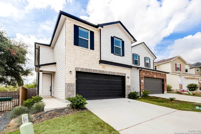 a front view of a house with a yard and garage