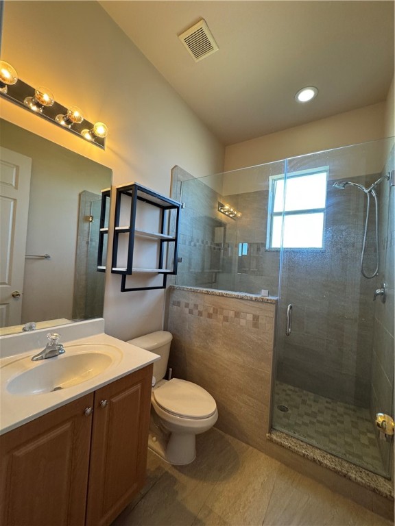 3318 Burlington Place Southwest Vero Beach, FL 32968 - Photo 26 of 30 a bathroom with a toilet a sink and glass door