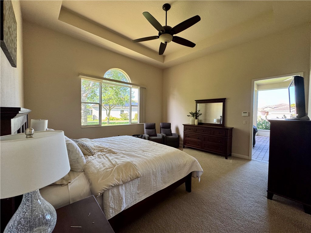 3318 Burlington Place Southwest Vero Beach, FL 32968 - Photo 6 of 30 a bedroom with a bed and a chandelier