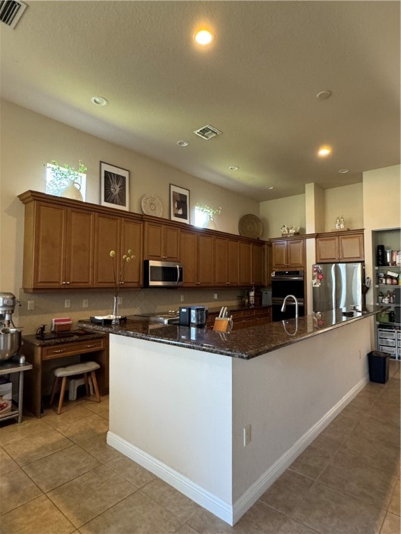 3318 Burlington Place Southwest Vero Beach, FL 32968 - Photo 9 of 30 a kitchen with kitchen island a sink a counter top space and appliances