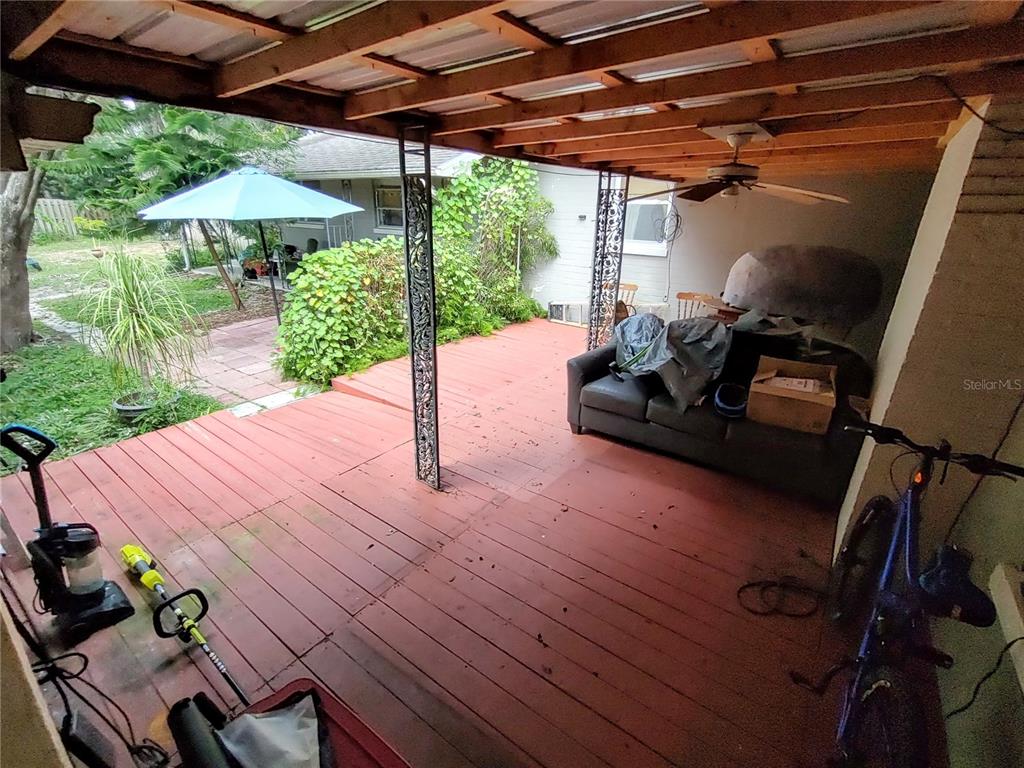 995 West 11th Avenue Mount Dora, FL 32757 - Photo 42 of 49 a roof deck with table and chairs under an umbrella with a barbeque