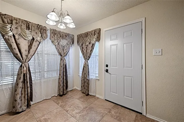 a view of living room with kitchen island furniture and a flat screen tv