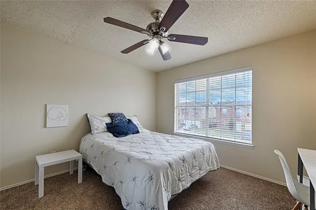 a bedroom with a bed and cabinets