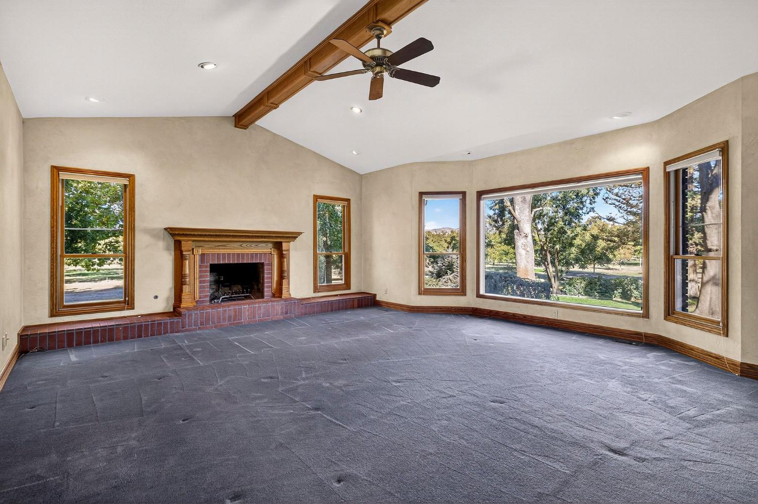 8970 South Butte Road Sutter, CA 95982 - Photo 15 of 86 a view of an empty room with a fireplace and a window