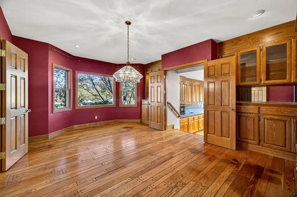 a view of an empty room with a fireplace and a window