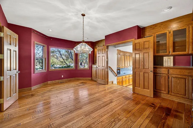 a view of an empty room with a fireplace and a window