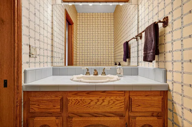 a bathroom with a sink and a mirror