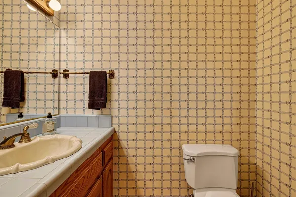 a bathroom with a tub a window and shower