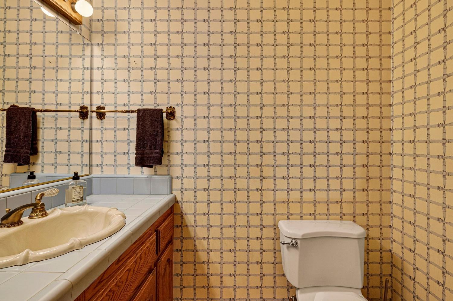 8970 South Butte Road Sutter, CA 95982 - Photo 33 of 86 a bathroom with a sink a toilet and a mirror