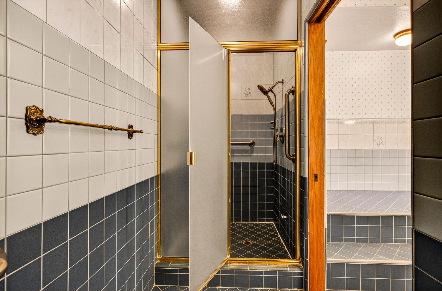 8970 South Butte Road Sutter, CA 95982 - Photo 38 of 86 a bathroom with a glass door shower and a mirror