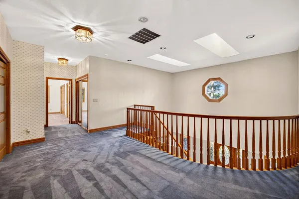 a car parked in front of a house and a yard