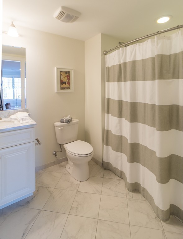 463 Rutherford Avenue, Unit 305 Boston, MA 02129 - Photo 11 of 19 a bathroom with a sink toilet and shower