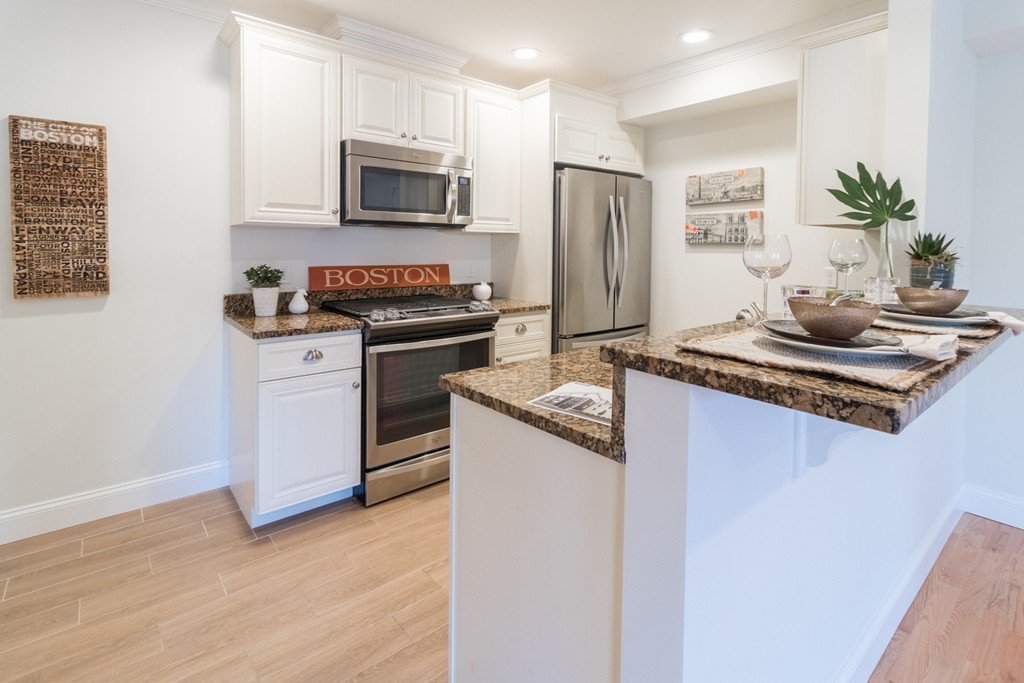 463 Rutherford Avenue, Unit 305 Boston, MA 02129 - Photo 6 of 19 a kitchen with stainless steel appliances granite countertop a stove a refrigerator and a microwave