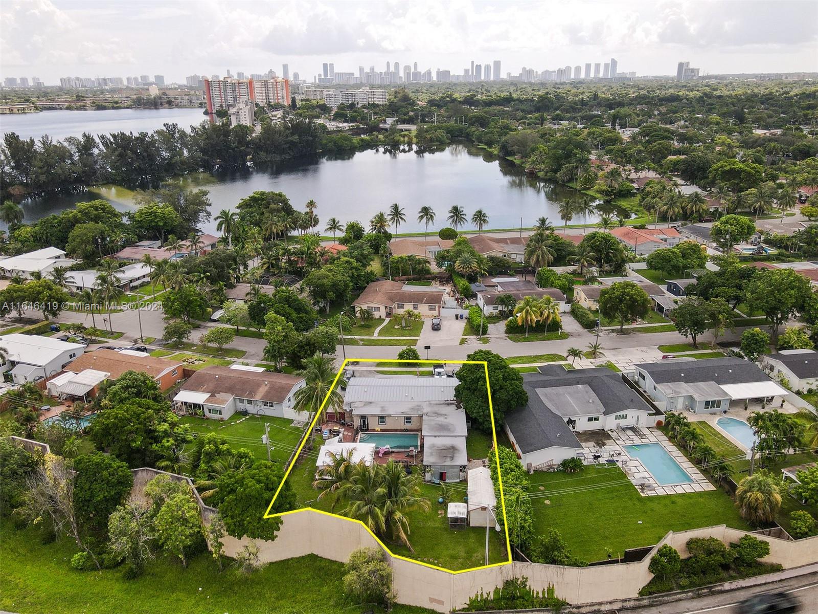 an aerial view of residential houses with outdoor space and lake view